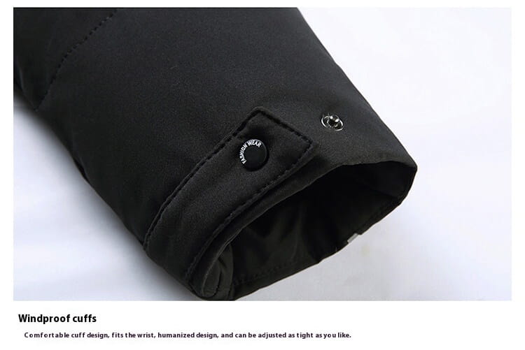 Black jacket cuff with adjustable snap buttons on a Mens Knee Length Coat with thermal insulation.