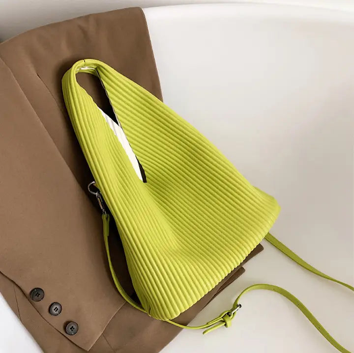 Neon yellow ribbed shoulder bag perfect for women’s niche fashionable style and textured messenger bag.