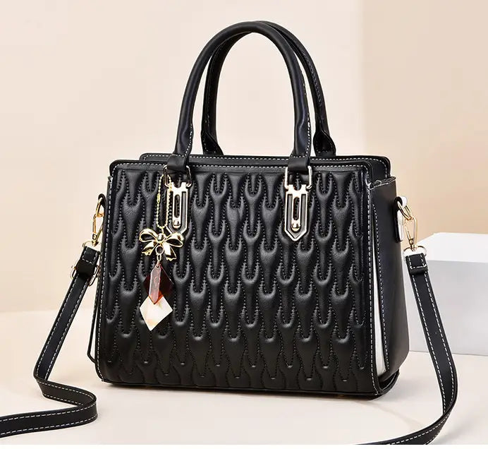 Black quilted handbag with gold hardware, perfect for a stylish high capacity fashion handbag.