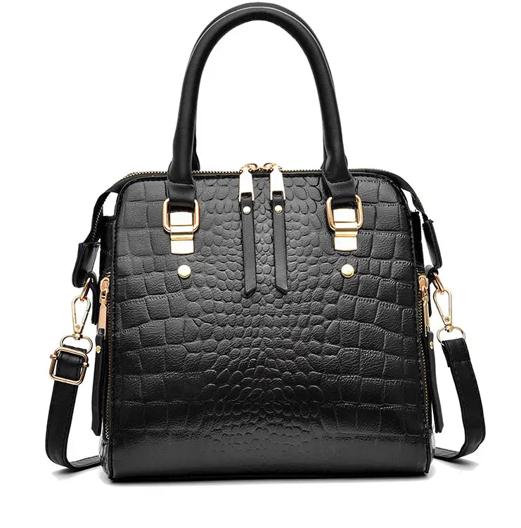 Black ladies crocodile print crossbody shoulder bag with gold hardware and strap.