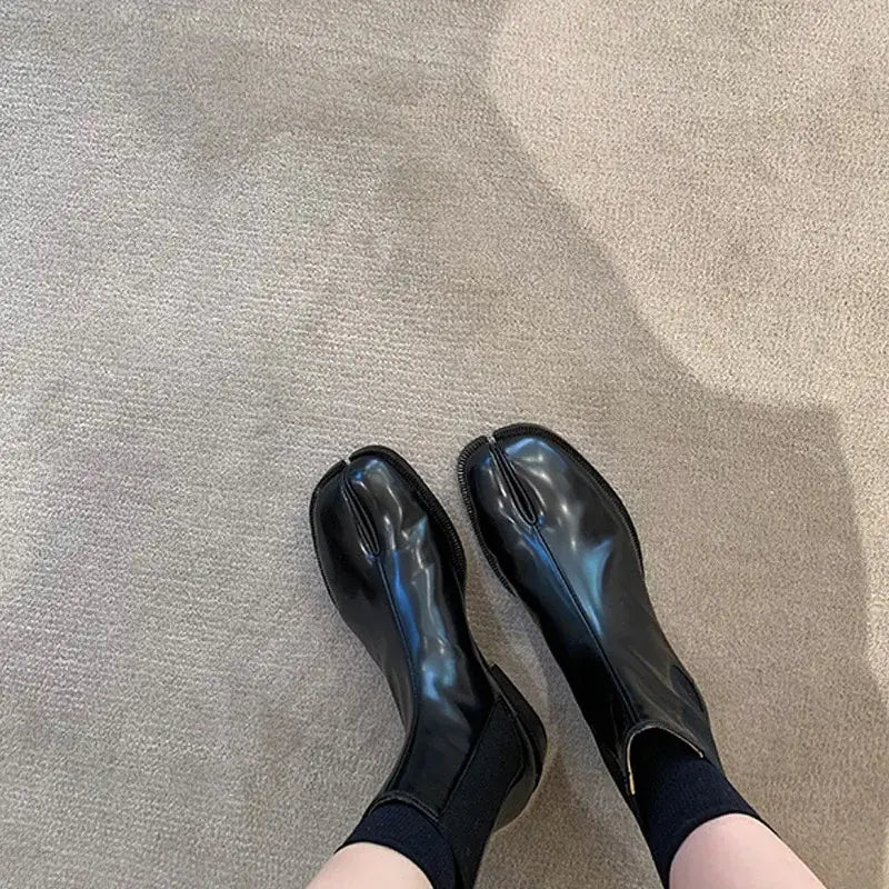 Black patent leather ballet flats with socks paired with Women’s Retro Split Toe Ankle Boots.