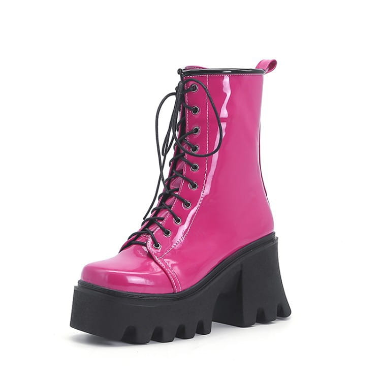 Hot pink patent boots with black soles and thick heels for a bold, stylish look.