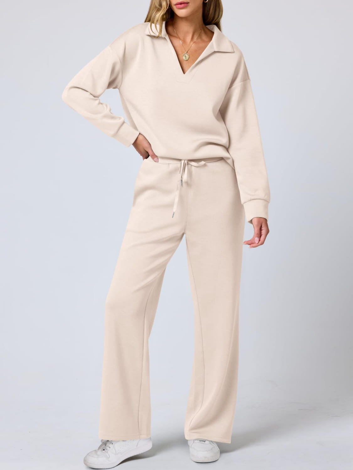 Cream-colored ladies two piece casual outfit set with collared top and drawstring pants.