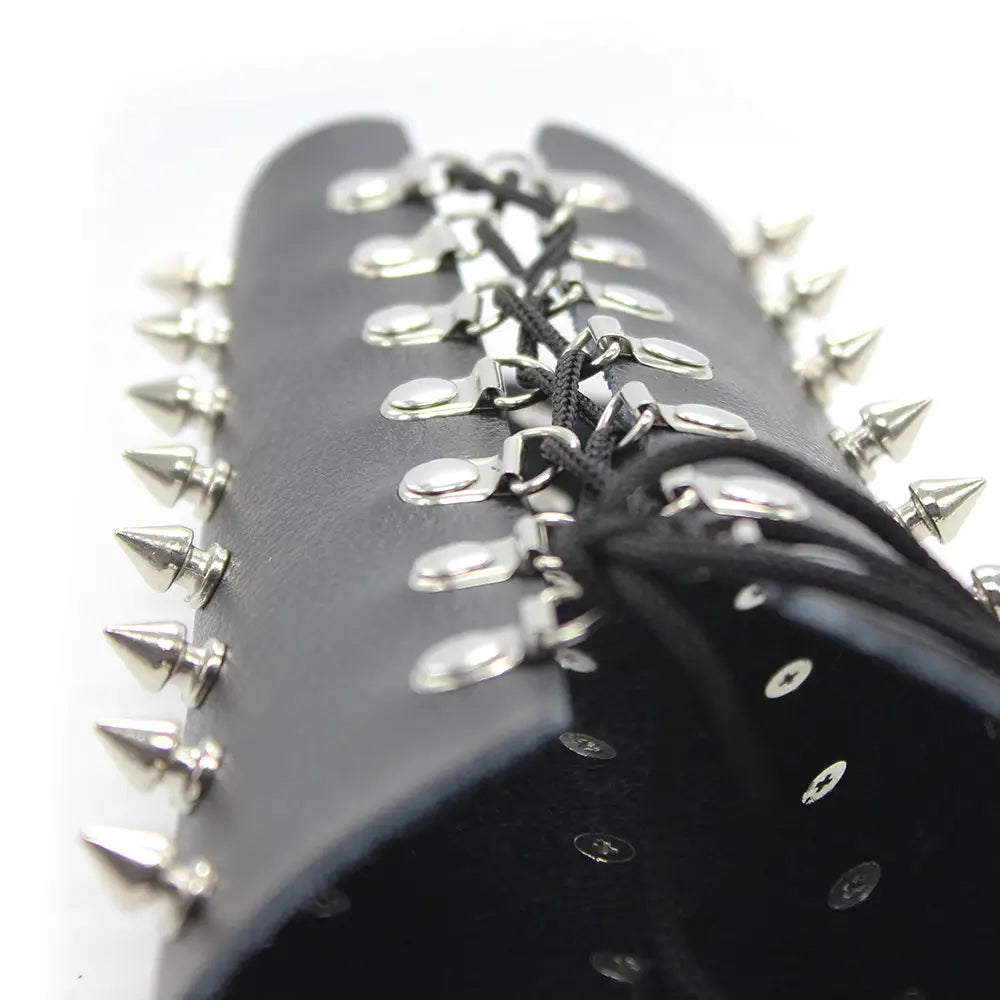 Black leather bracelet with spikes, perfect for nail bondage armor and erotic bondage straps.