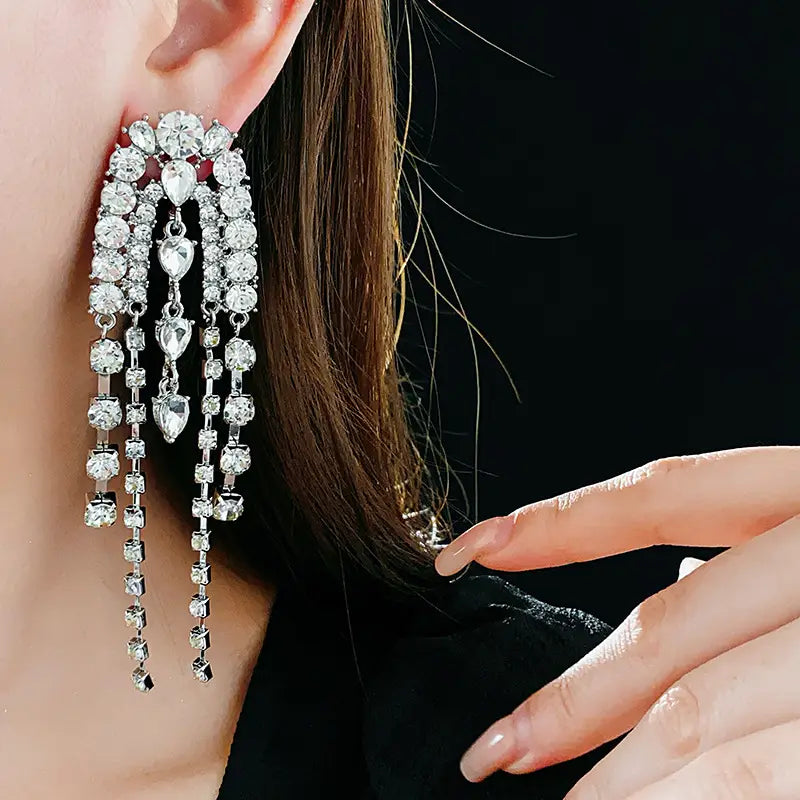 Sparkling water droplet shaped luxury tassel earrings with dazzling crystal strands.