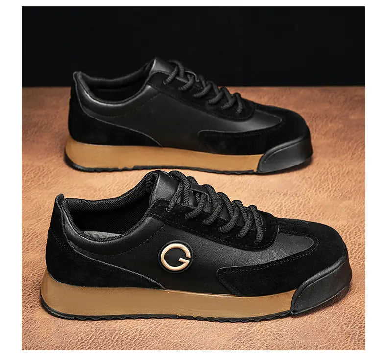 Black casual flat trainer shoes with a circular logo and gum soles for men.