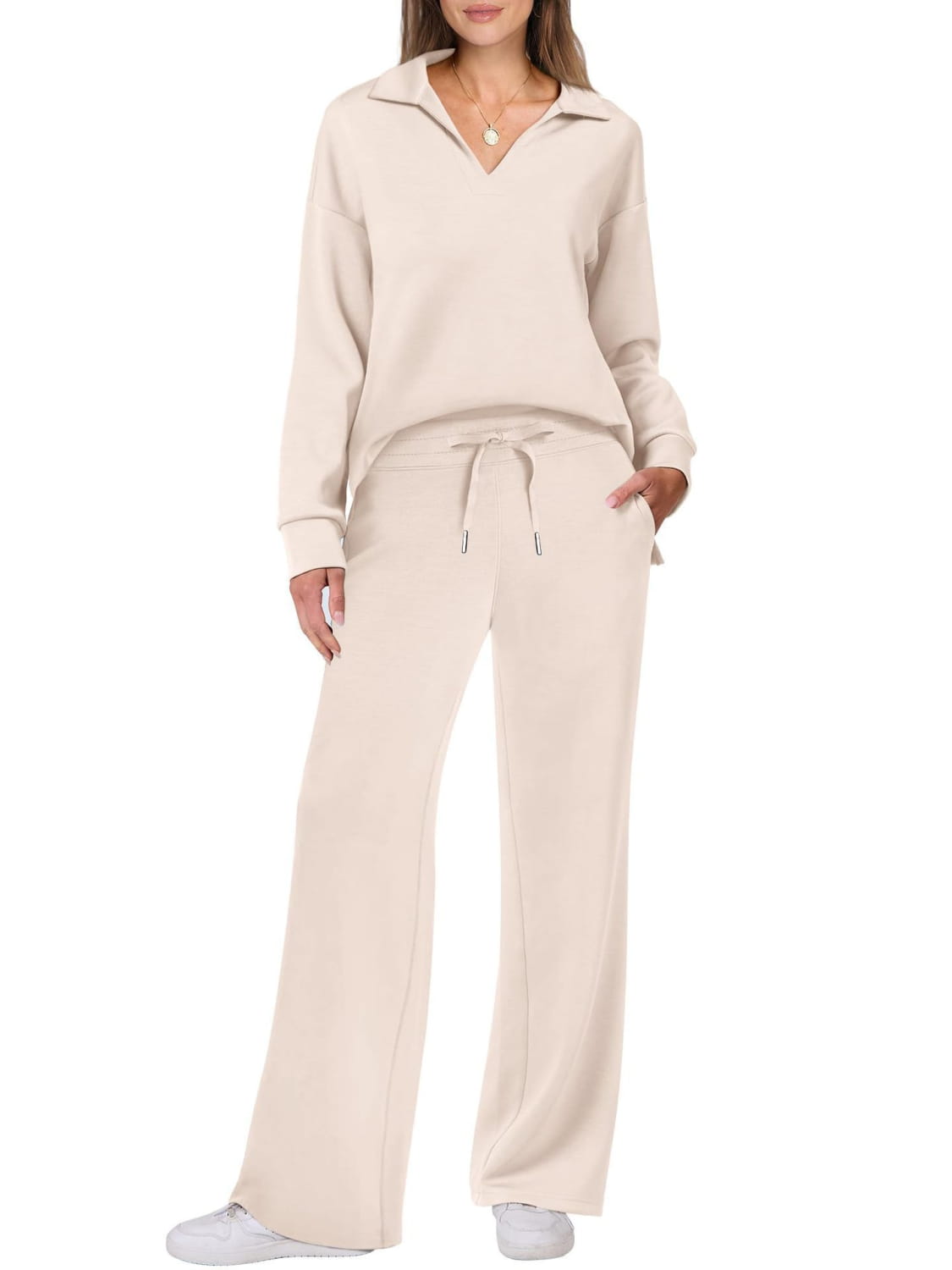 Cream-colored knit ladies two piece casual outfit set with pockets and drawstring pants.