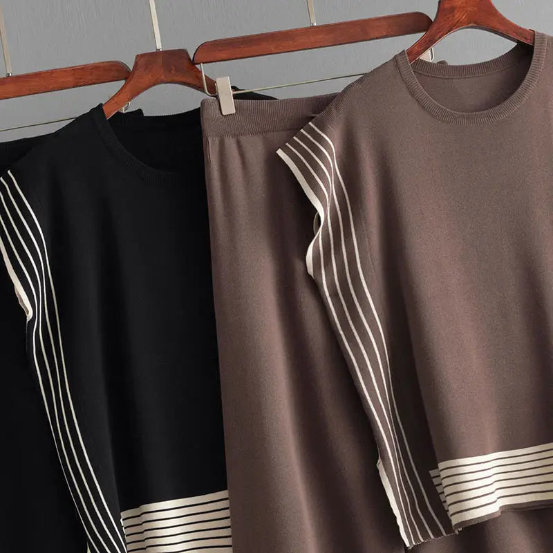 Two stylish round neck knitted sweaters with stripes on wooden hangers, perfect for a set high waist look.