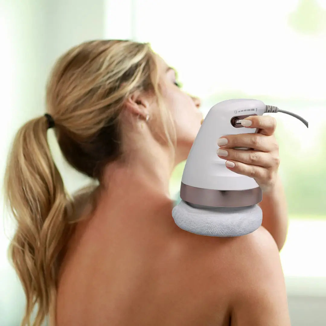 Handheld electric massager providing body sculpting relief on bare shoulders.