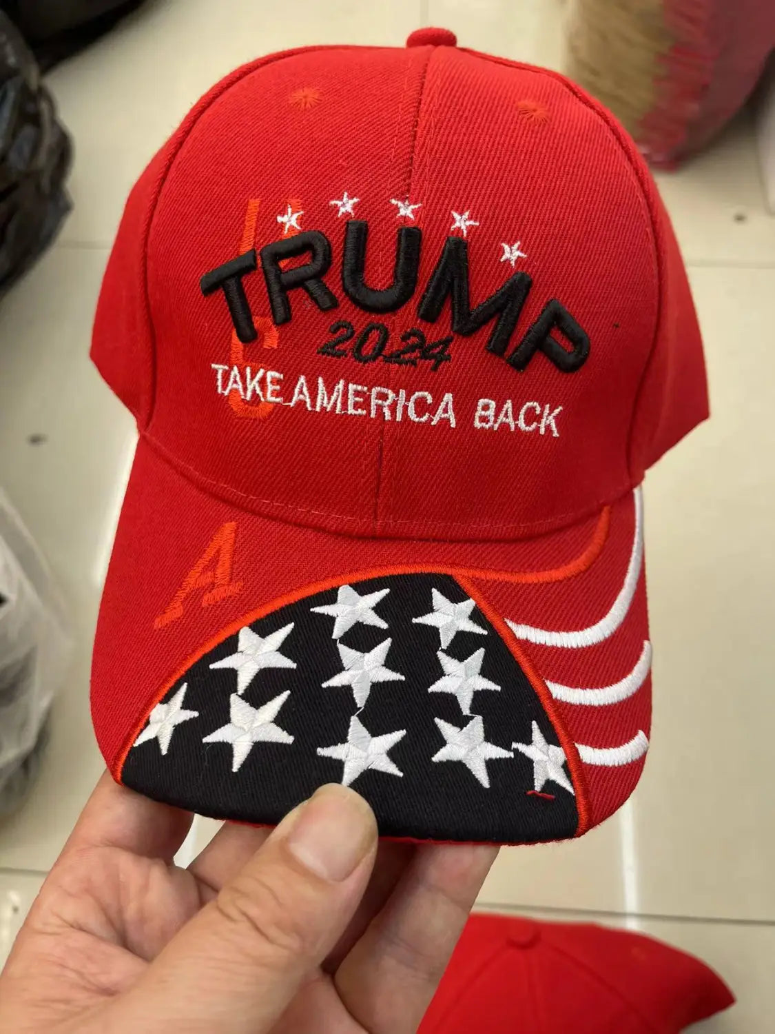 Red Donald Trump embroidered baseball cap with American flag and values design.