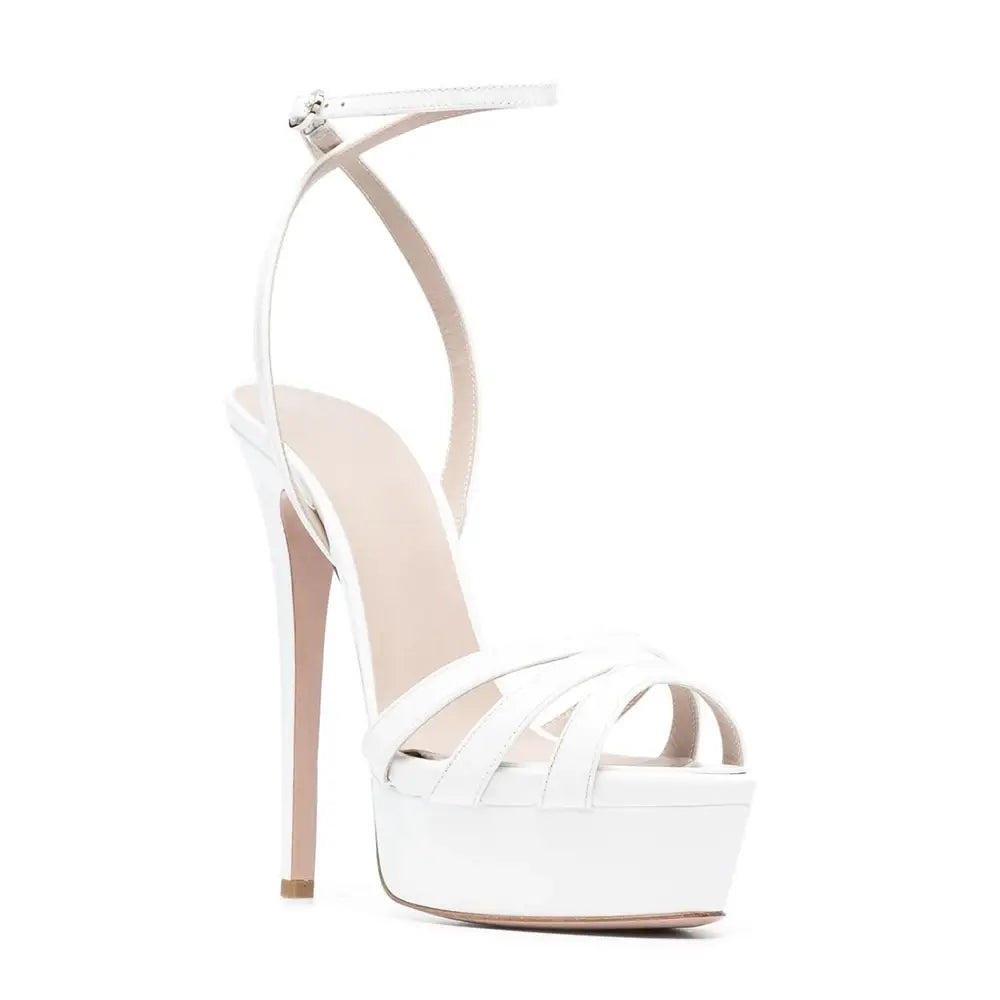 White strappy platform sandals with ankle buckle and slim heels ready for stylish wear.