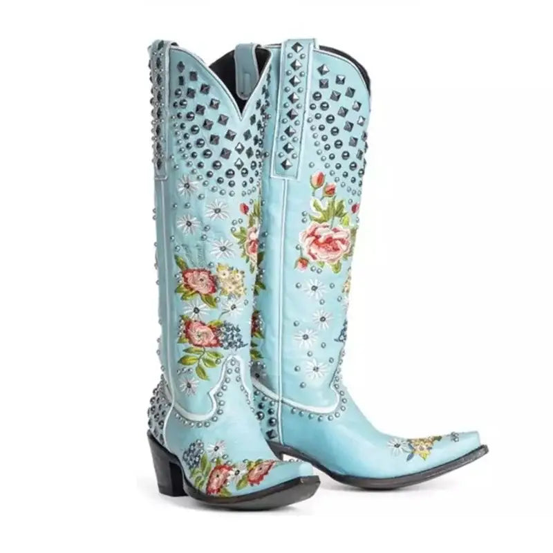 Light blue pointed toe women’s ethnic style embroidered studded cowboy boots with flowers.