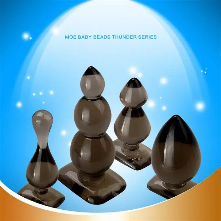 Four dark silicone butt plugs in various sizes, perfect for waterproof fun with sex toys.