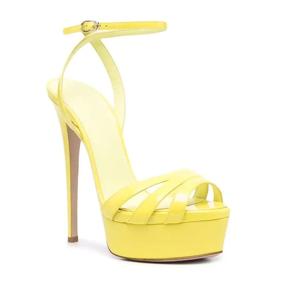 Yellow platform sandals with ankle buckle and crossed straps for a stylish look.