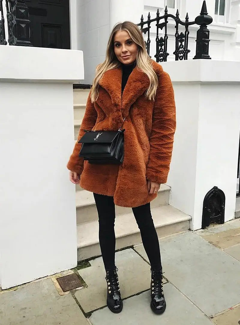 Rust-colored teddy coat with black bag and boots for a cozy chic fur plush look.