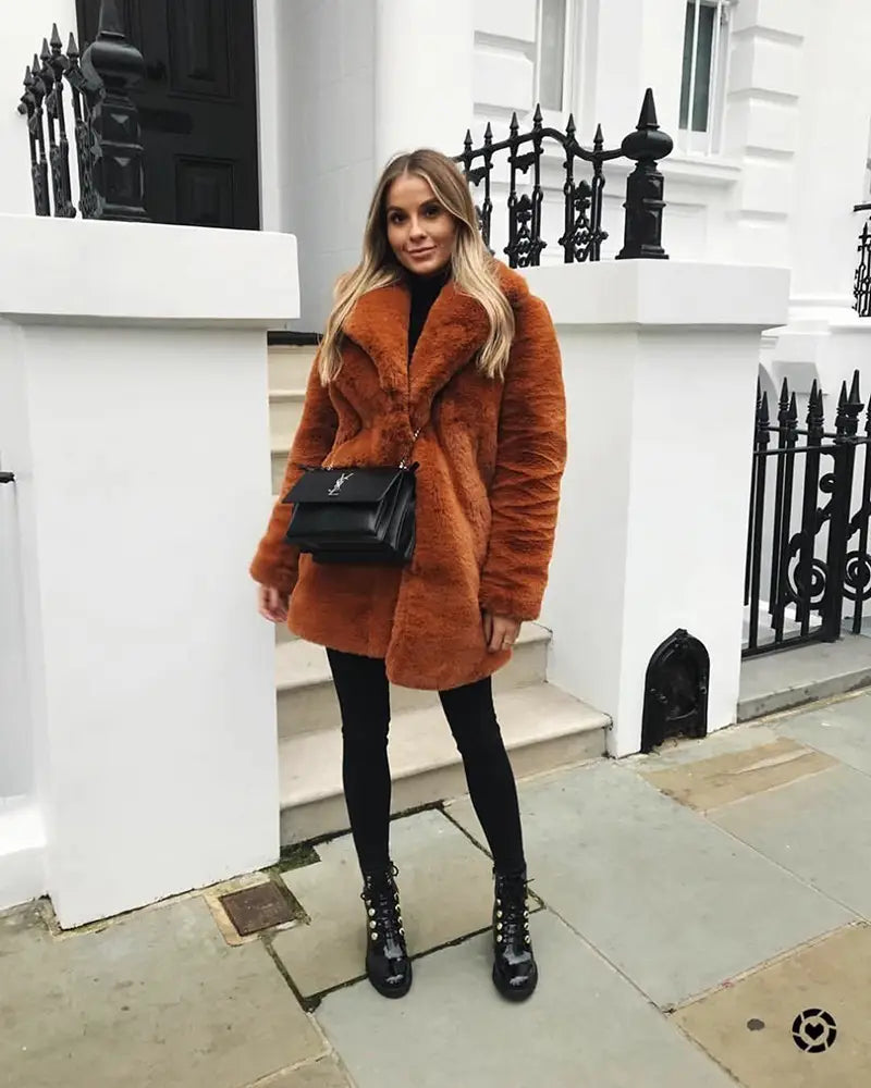 Chic rust-colored fur coat with black crossbody bag for cozy wine red vibes.