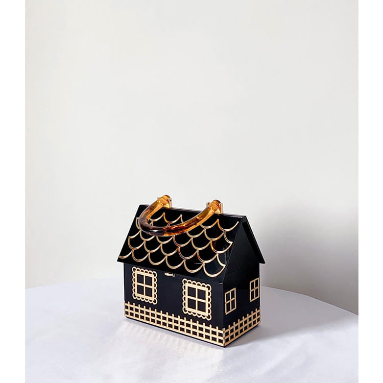 Stylish house shaped handbag in black and gold with luxury designer acrylic handle.