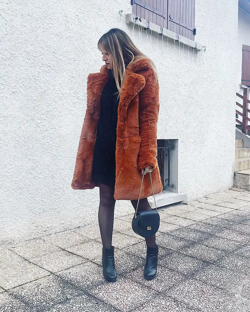 Stylish fur plush warm coat in wine red paired with a black dress and ankle boots.