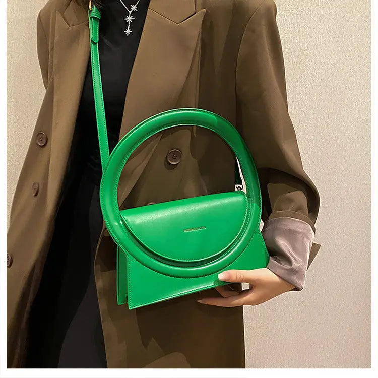 Bright green geometric designer handbag versatile for shoulder crossbody use.