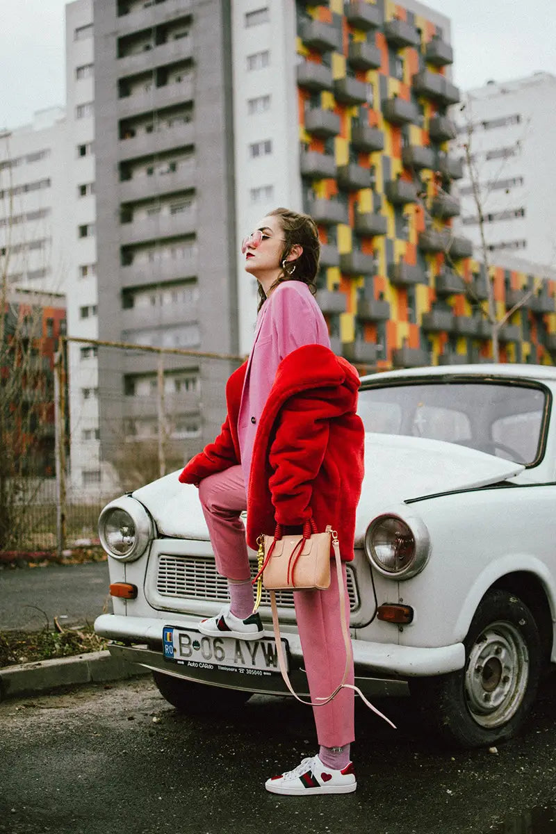 Classic white Trabant car with chrome bumper and wine red fur plush warm coat vibe