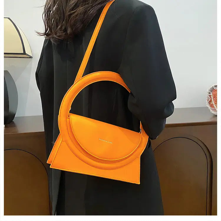 Bright orange half-moon handbag versatile for stylish shoulder crossbody bag use.