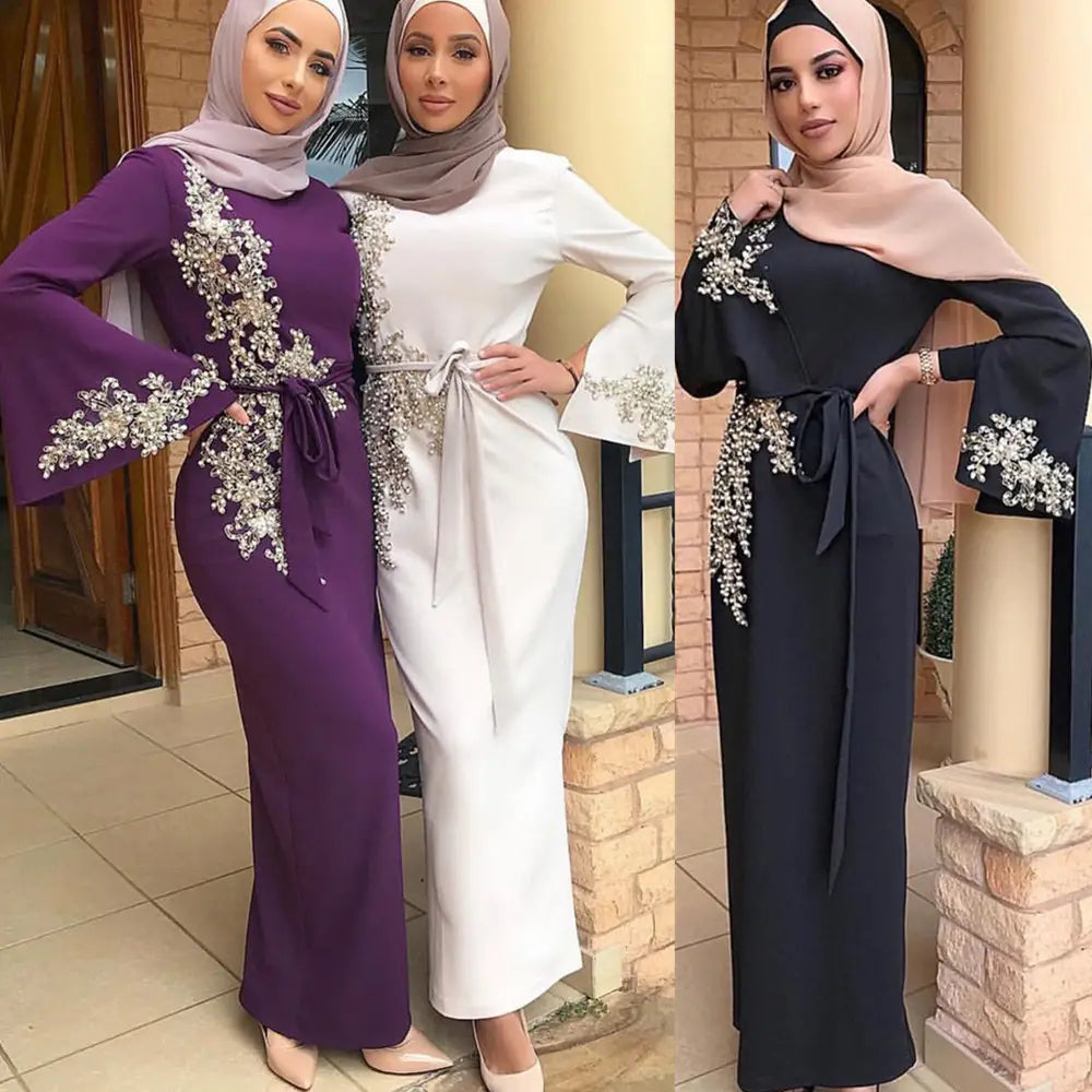 Three stylish Ladies Muslim Embroidered Dresses in black, purple, and white with floral embroidery.