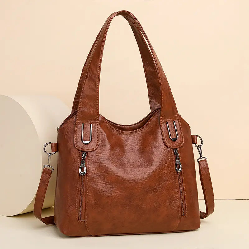 Brown leather large capacity handbag with dual handles and stylish zipper details