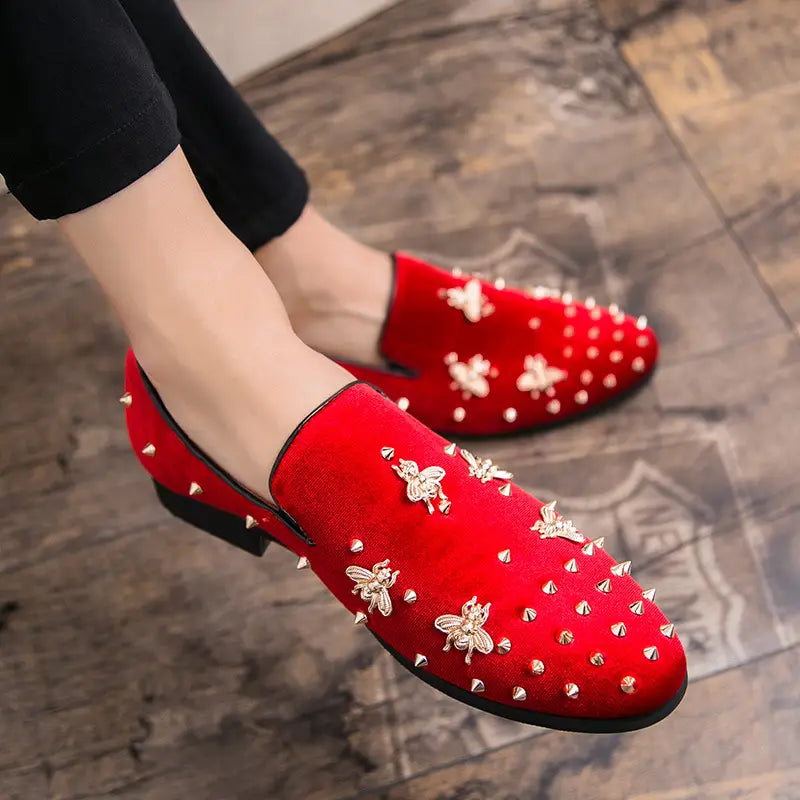 Red studded loafers with bee embroidery, perfect for casual style and men’s fashion.