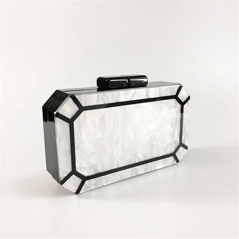 Geometric white clutch purse with black trim in Art Deco Design for stylish evenings.