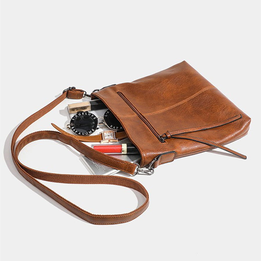 Brown leather crossbody bag featuring high-end textured artificial leather design.