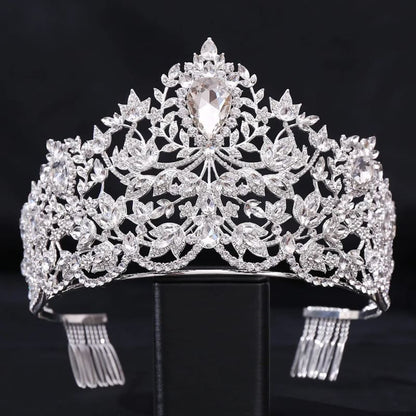 Ornate silver tiara adorned with intricate floral patterns and sparkling gemstones.