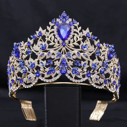 Ornate tiara featuring blue gemstones and intricate metalwork designs.