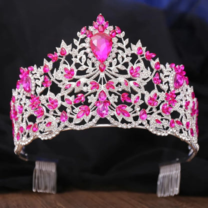 Ornate tiara with silver filigree and vibrant pink gemstones.