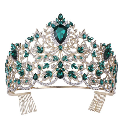 Ornate tiara adorned with emerald-colored and clear gemstones in an intricate floral design.