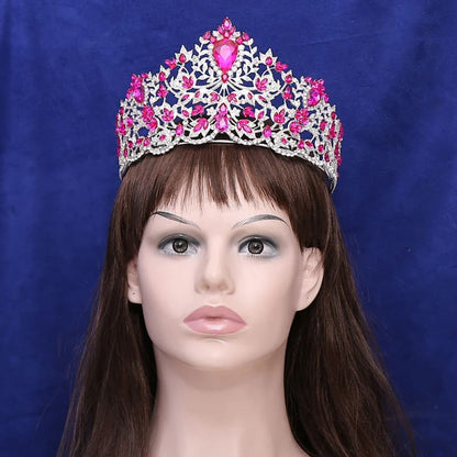 Ornate tiara with pink gemstones and intricate silver metalwork.