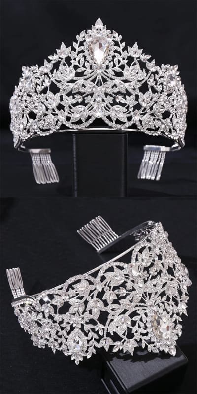 Ornate silver tiara with intricate floral and leaf designs adorned with crystals or diamonds.