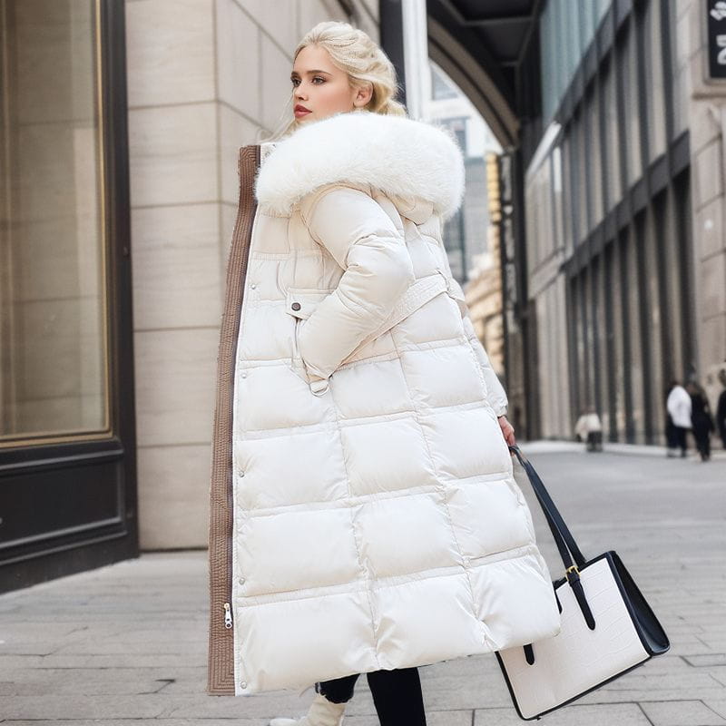 White ladies long padded coat with luxurious fur-trimmed hood for cozy winter style.