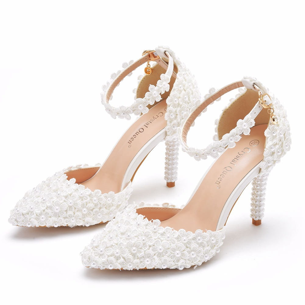 White lace bridal heels with ankle straps and pearl embellishments for a stunning look.