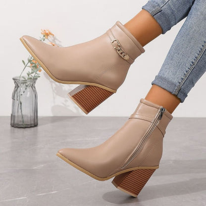 Beige ankle boots with chunky wooden heels and decorative buckle details.