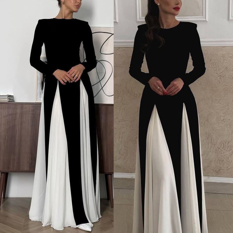 Long-sleeved black and white color-blocked gown with a fitted bodice and flowing skirt.