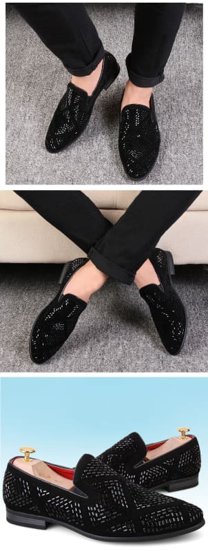 Black leather loafers with decorative perforations and a slip-on style.