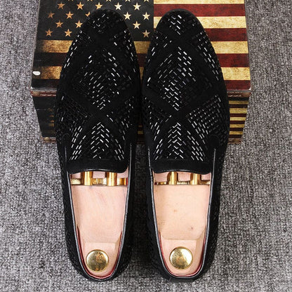 Pair of black woven leather loafers with gold accents.