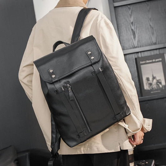 Black leather backpack with metal hardware and a flap closure.