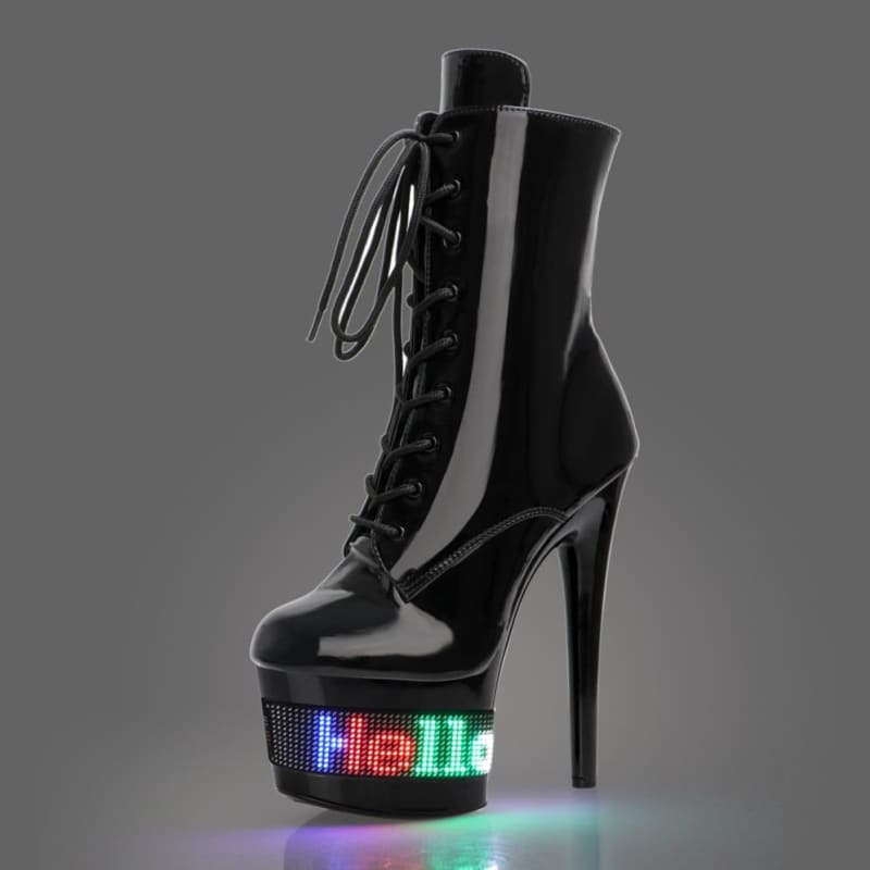 High-heeled black boot with a lighted platform displaying the word ’Hello’ in colorful LEDs.