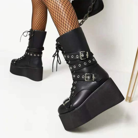 Black platform ankle boots with buckles, studs, and lace-up details.