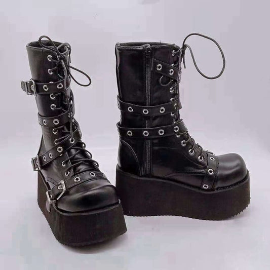 Pair of black leather platform boots with buckles and laces.