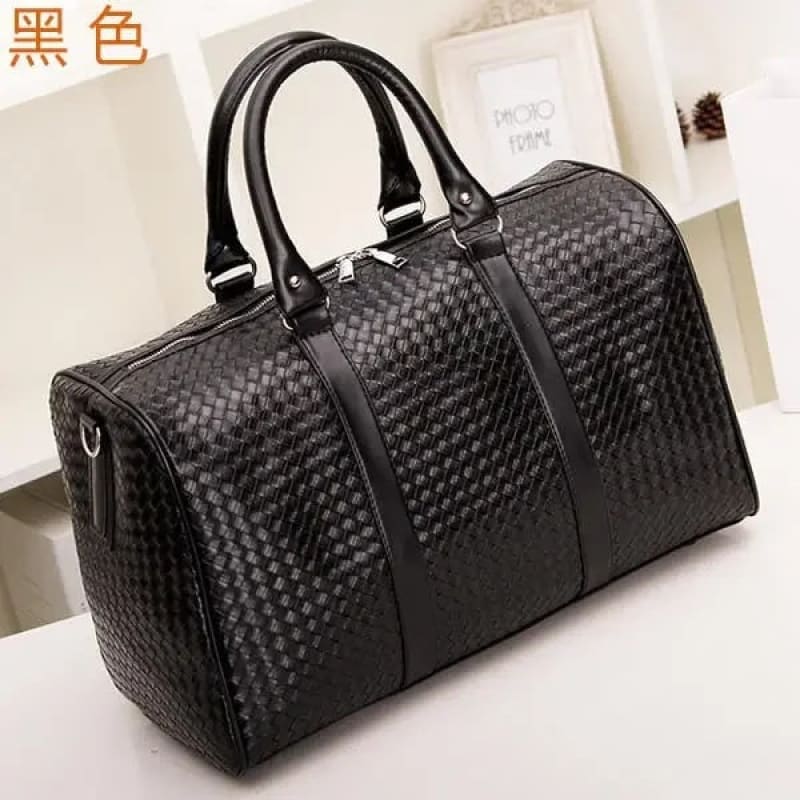 Black leather duffle bag with a woven pattern and dual handles.