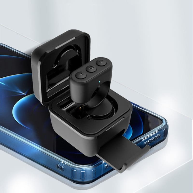 Wireless earbud in its charging case, positioned on top of a smartphone.