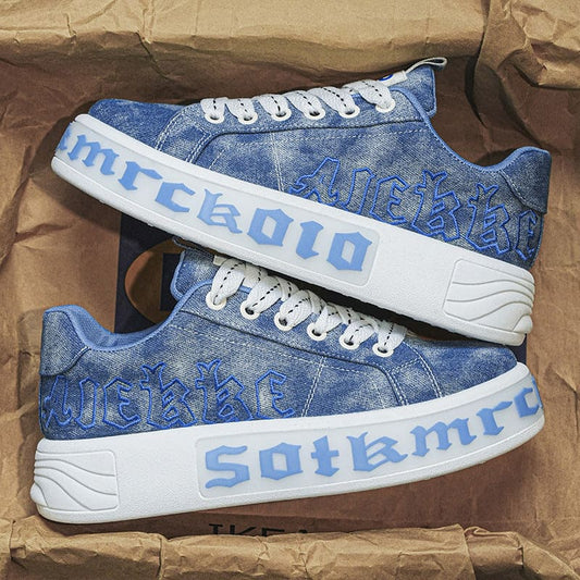 Pair of blue denim sneakers with white soles and ’Sotamrco’ branding.