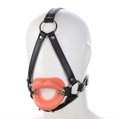 Leather harness with a bright orange mouth gag attached.